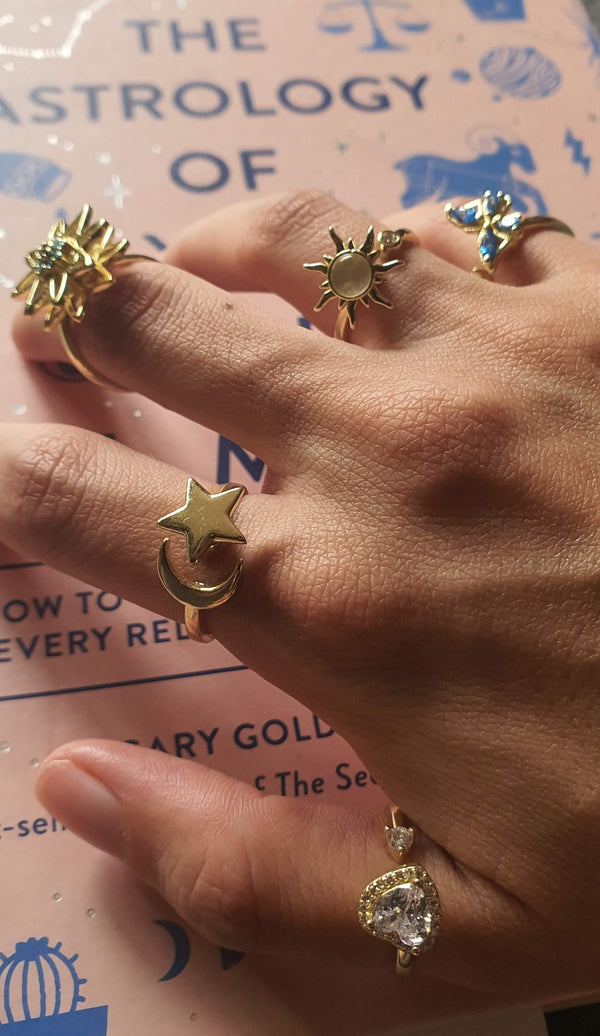 Hand wearing gold fidget rings on different fingers to illustrate finger placement and symbolism in ring meaning