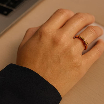 A woman hand with a fidget ring working at her desk