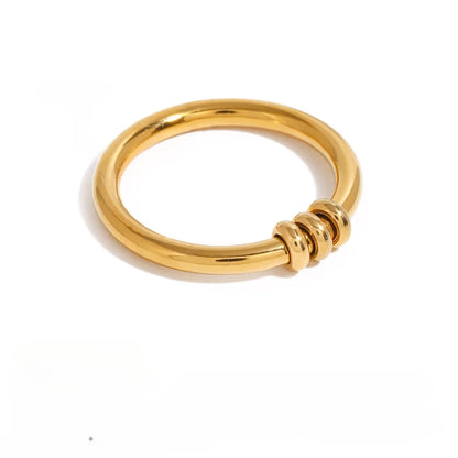 A gold fidget ring with three mini rings you can move on the band. Discreet and minimalistic.